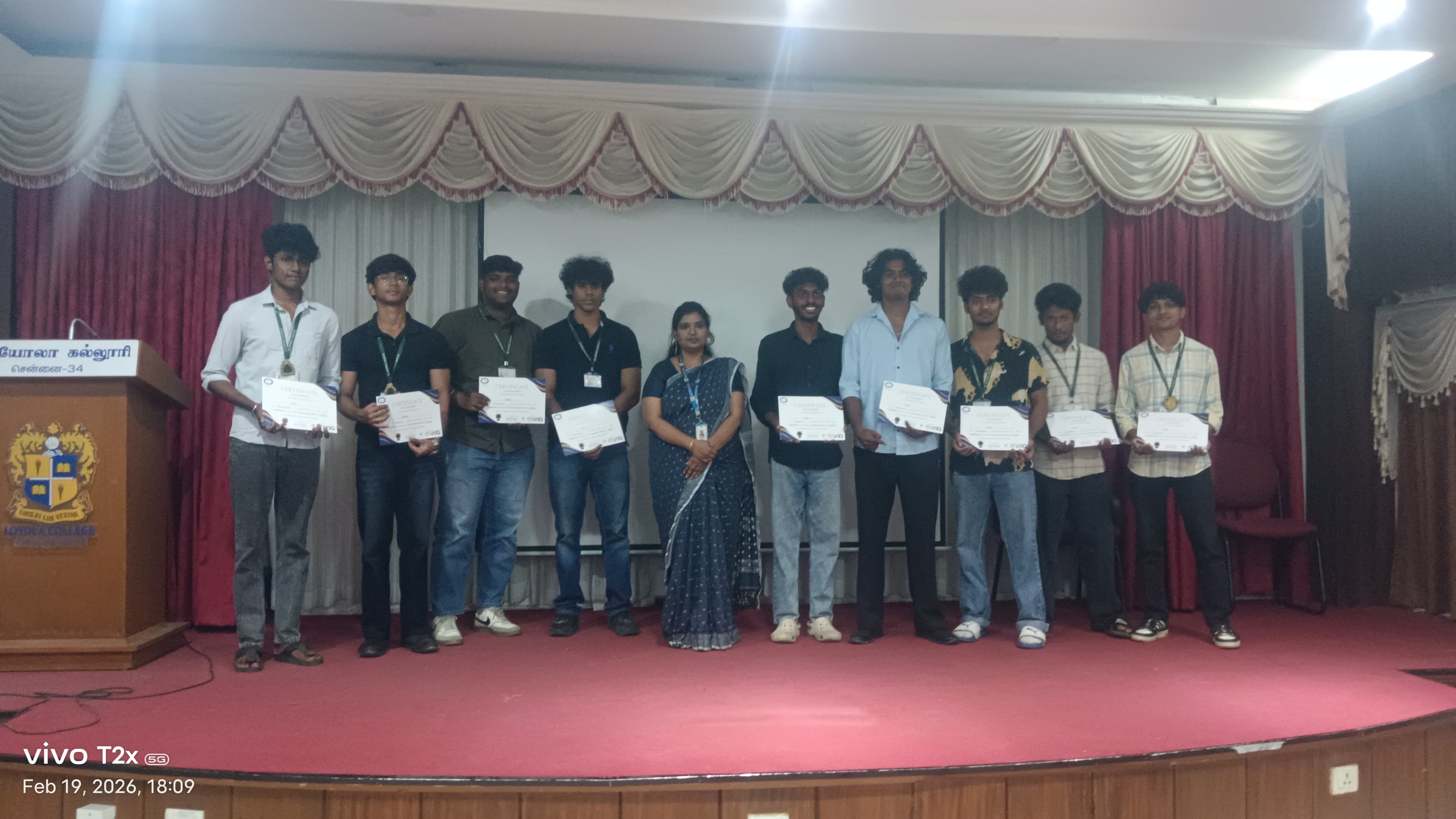 College students receiving certificates on stage in front of their peers