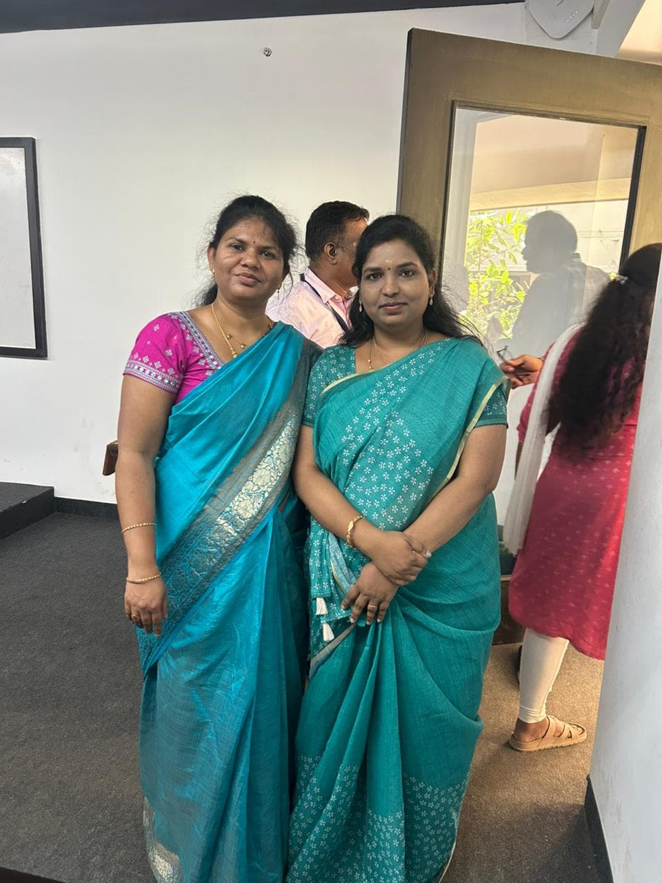 Two facilitators standing together at a training event