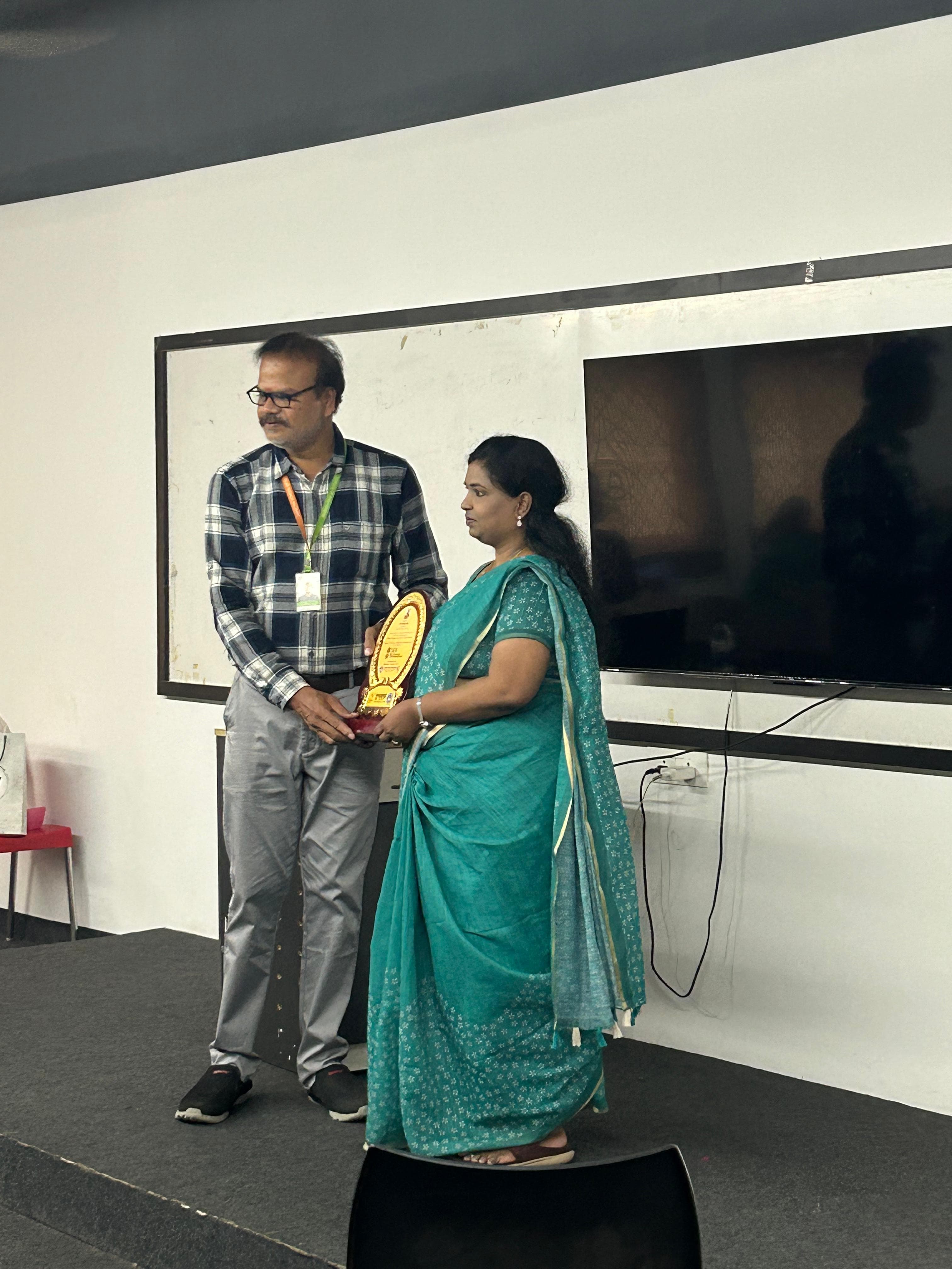 Corporate award being presented to an employee in an office