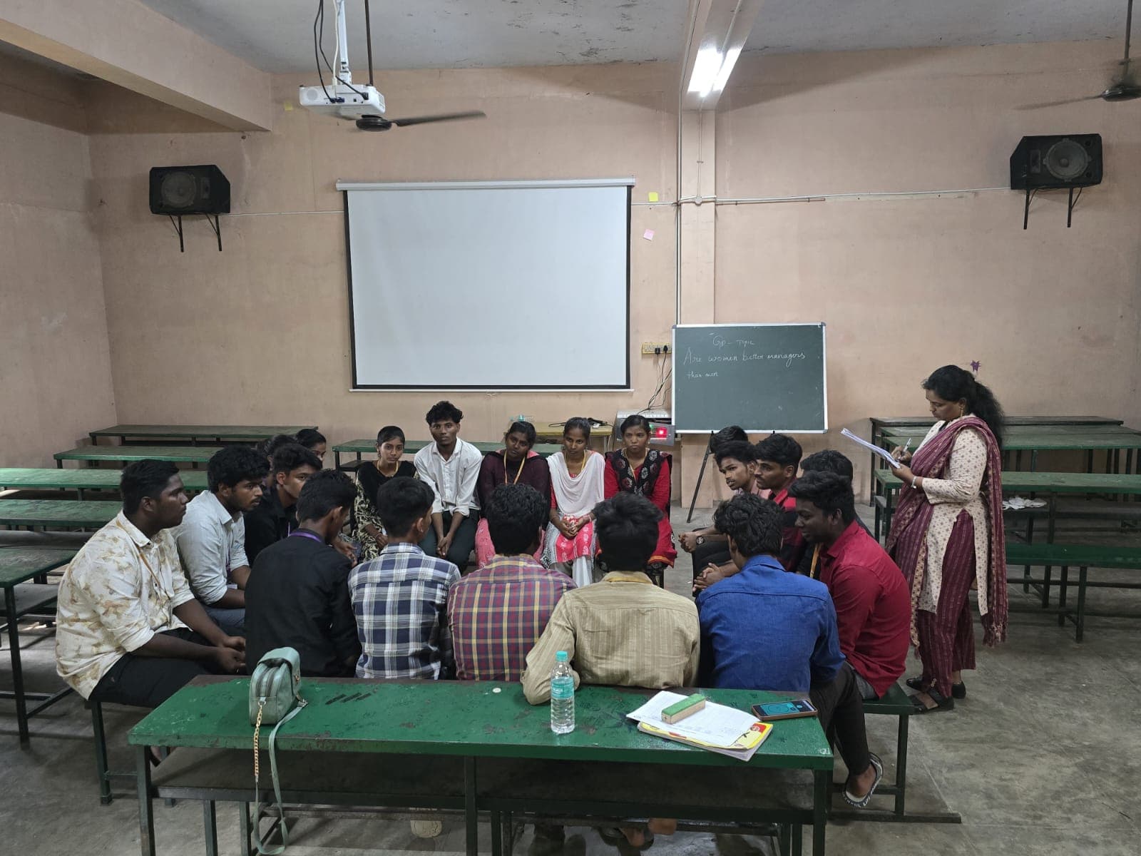 Students seated in a circle for a group discussion exercise in a classroom