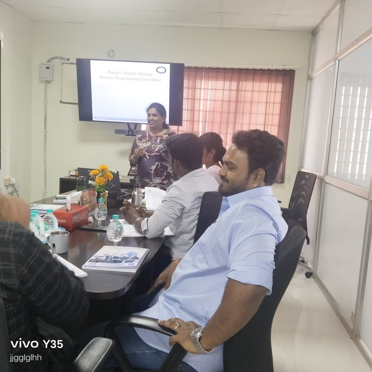Trainer presenting a positive mental attitude session to a corporate group