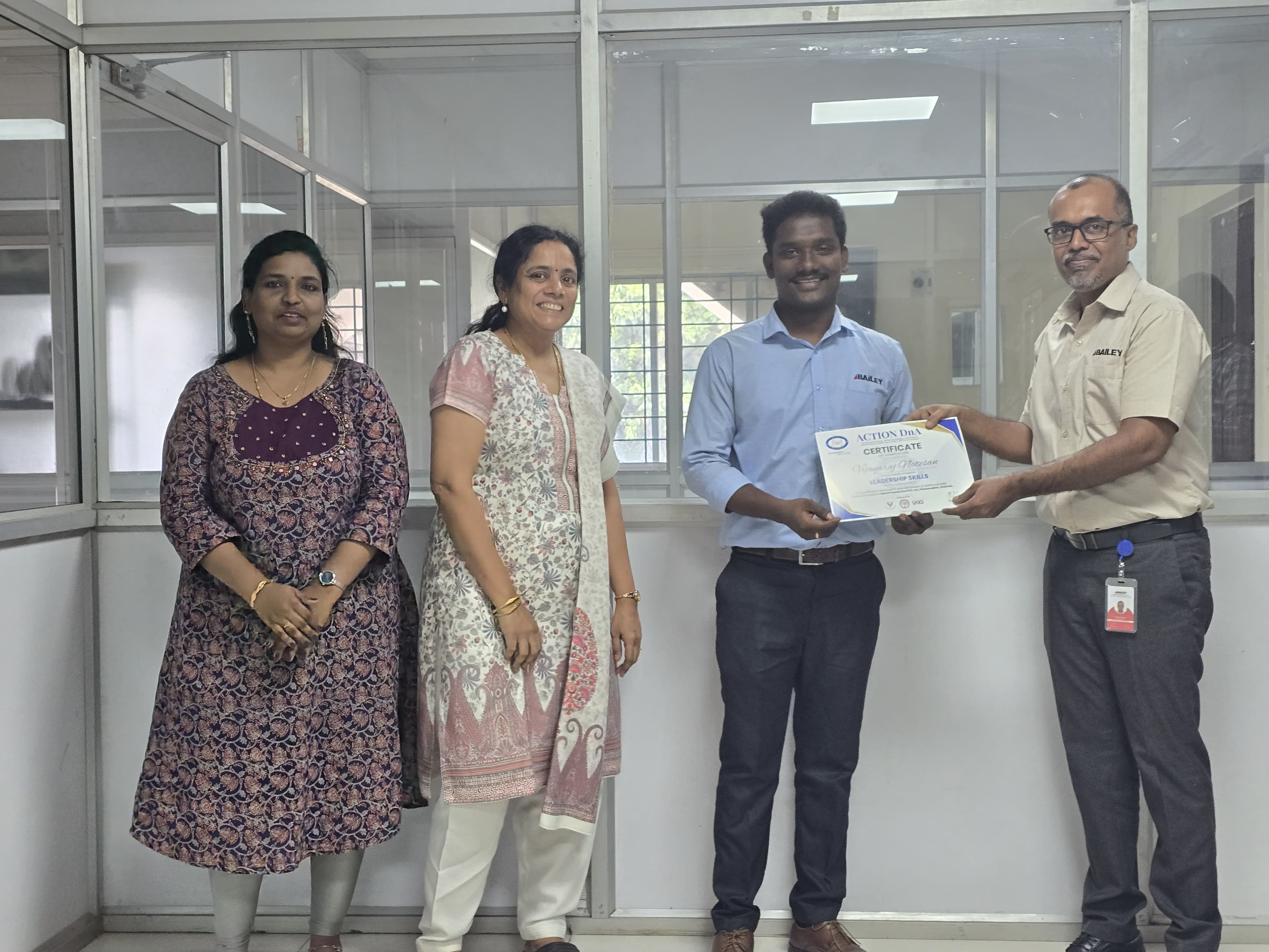 Employee receiving a leadership skills certificate in an office