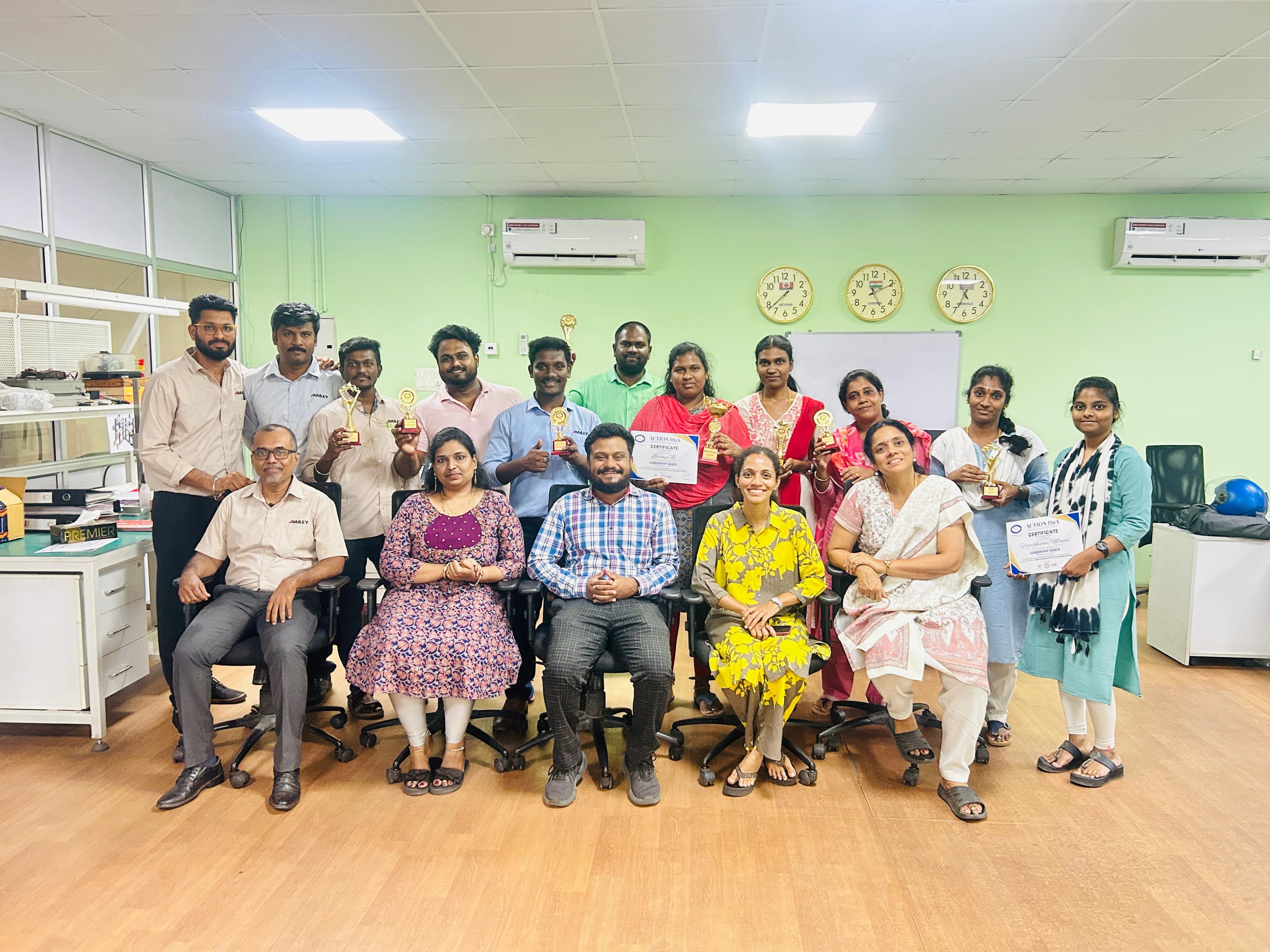 Corporate team group photo with trophies and certificates
