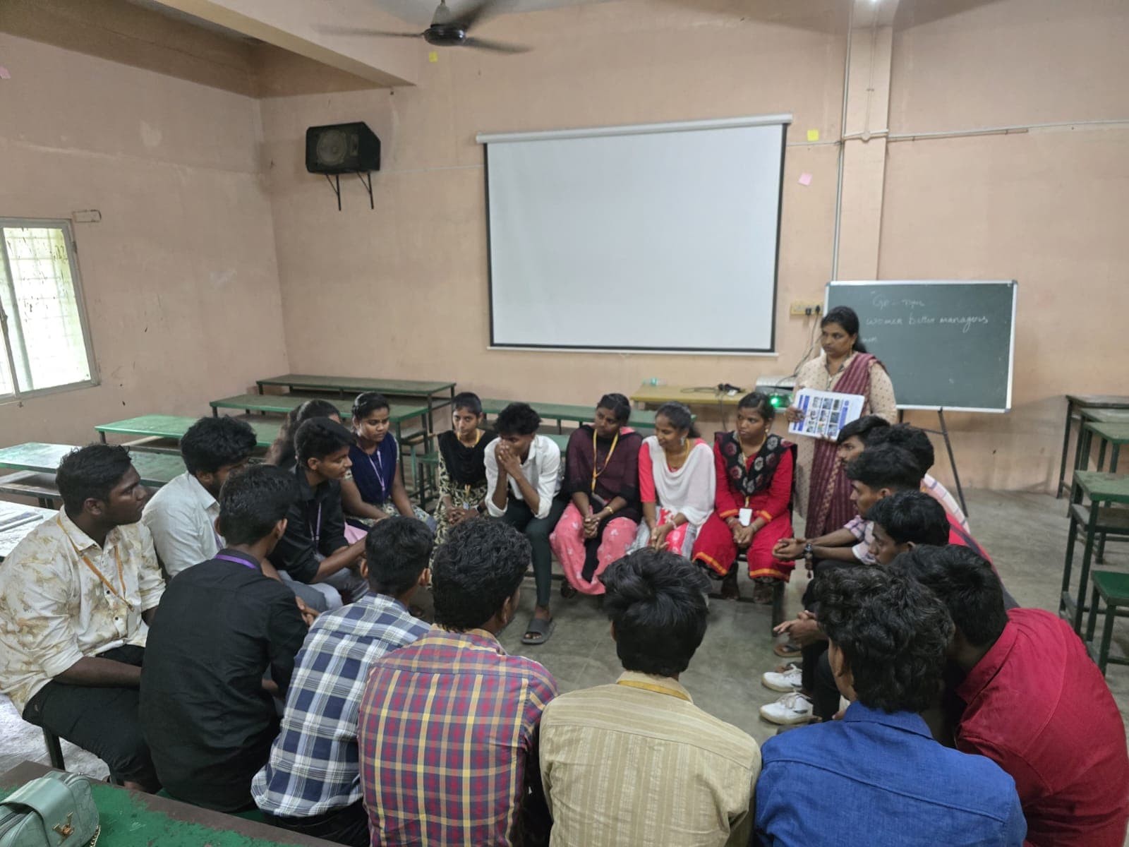 Students seated in a circle for a group discussion exercise in a classroom