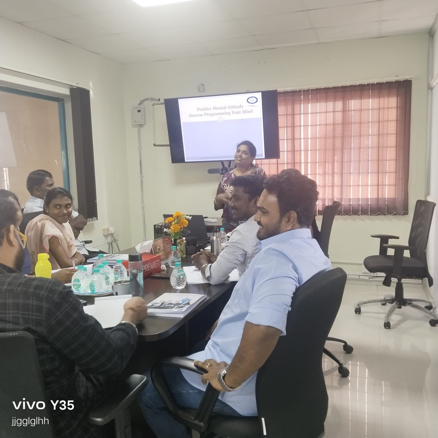 Trainer presenting a positive mental attitude session to a corporate group
