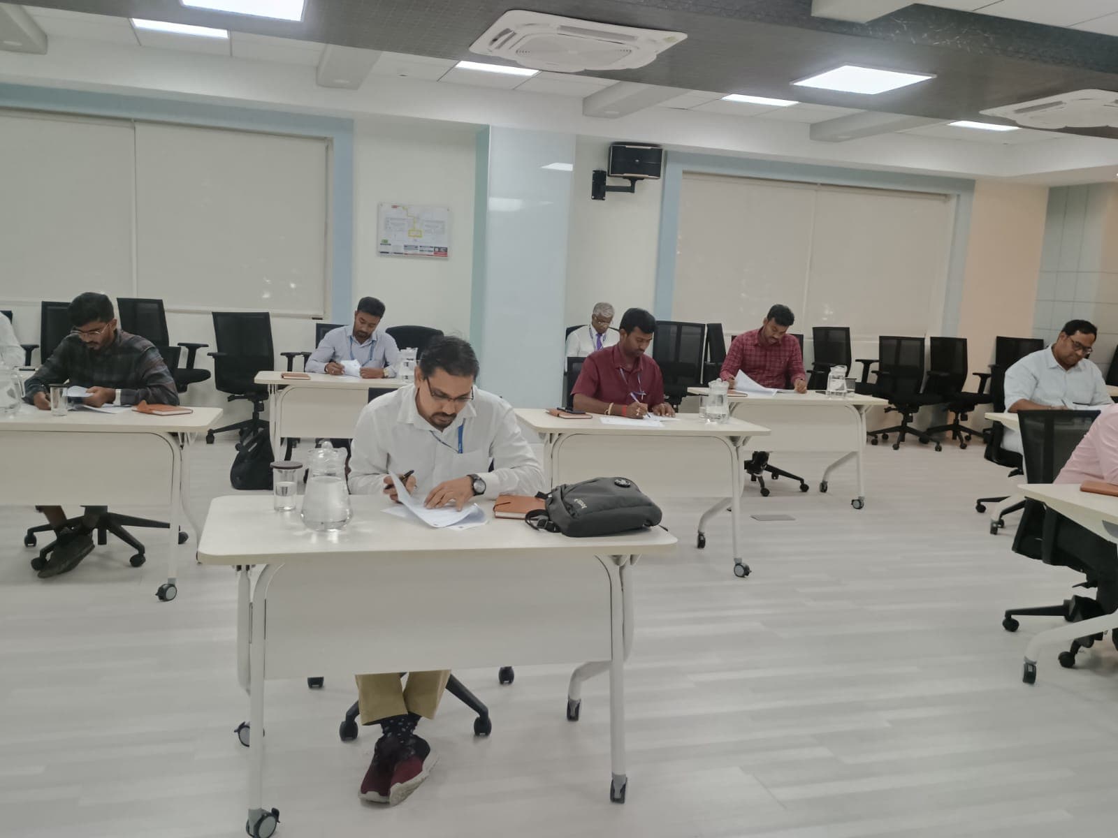 Participants seated at desks during a corporate assessment session