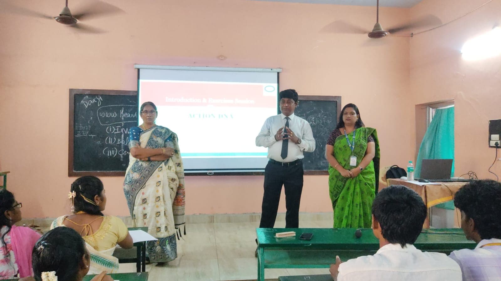 Facilitators introducing a training programme to a seated classroom group