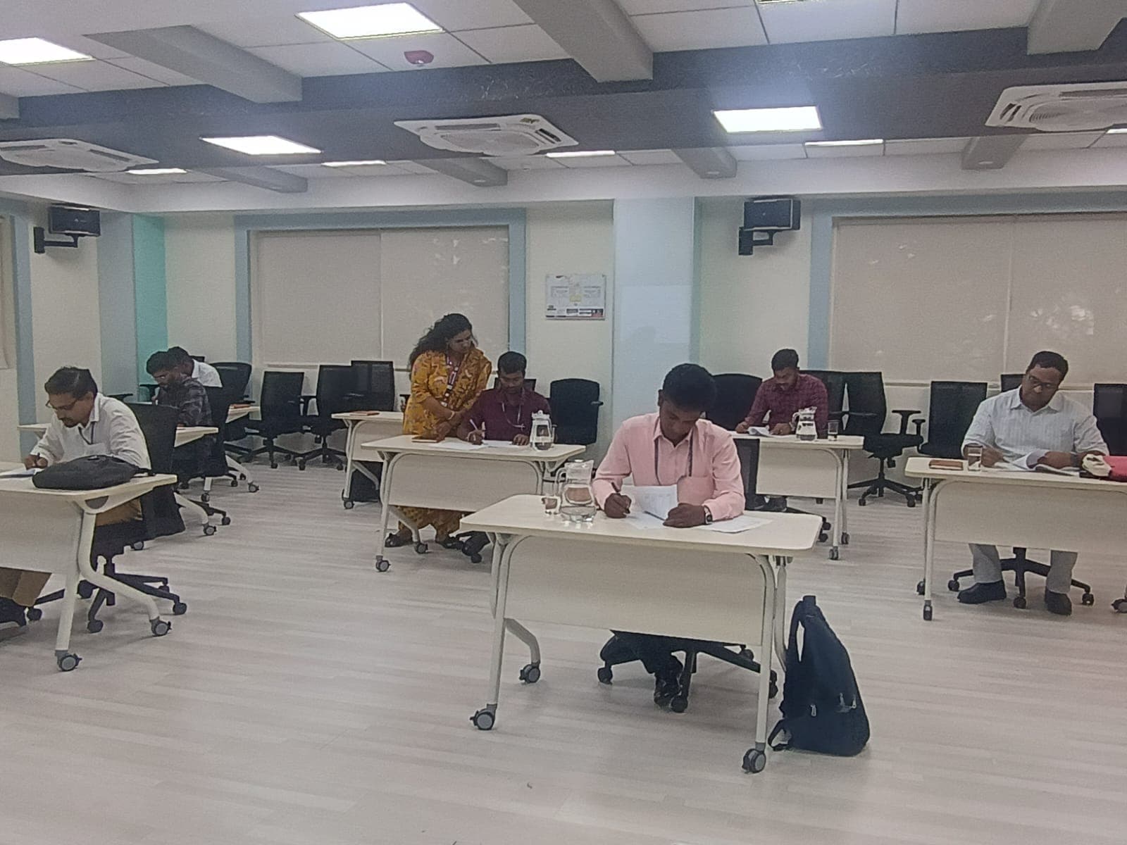 Participants seated at desks during a corporate assessment session