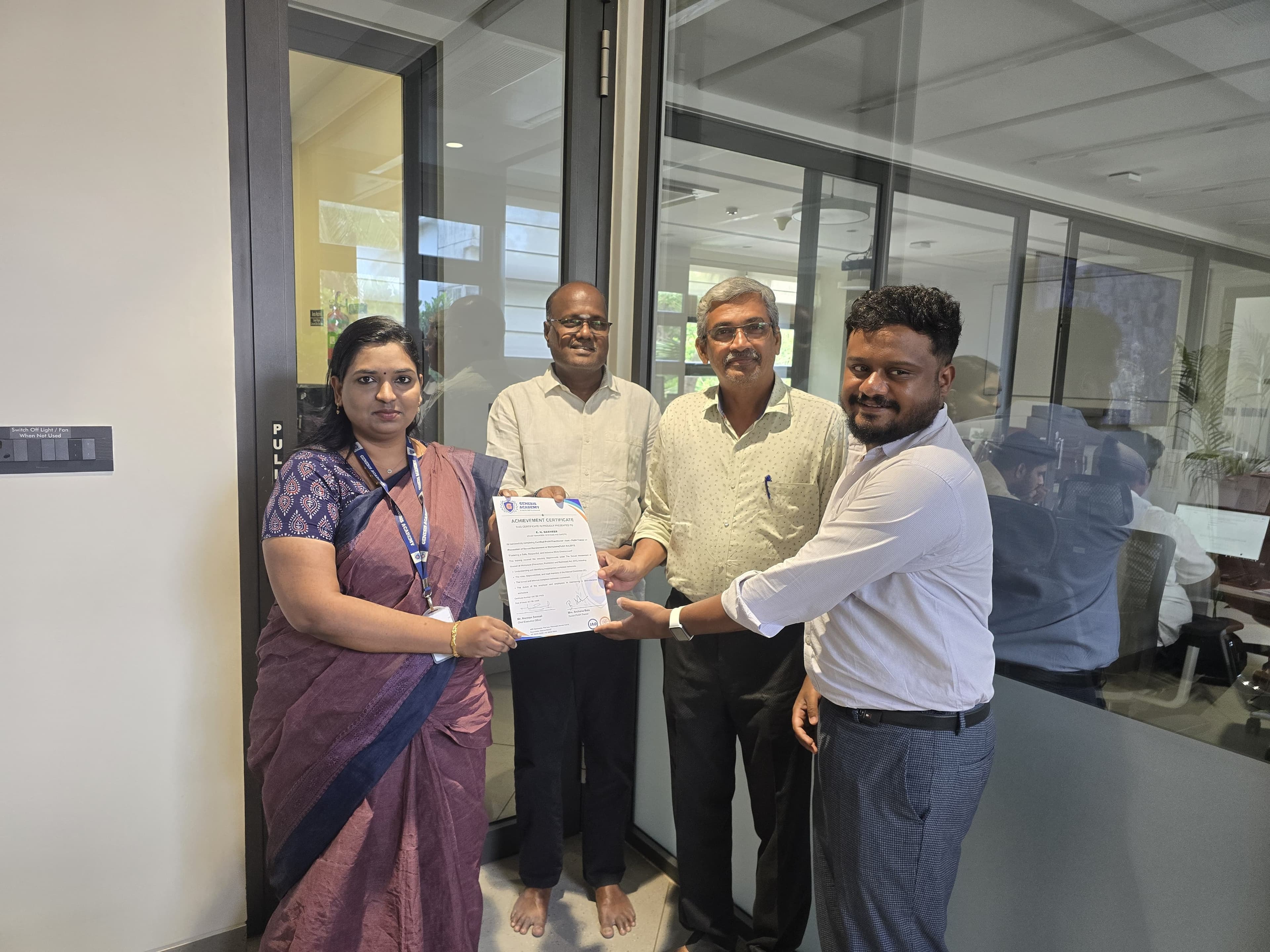 Achievement certificate being presented to a trainer in an office