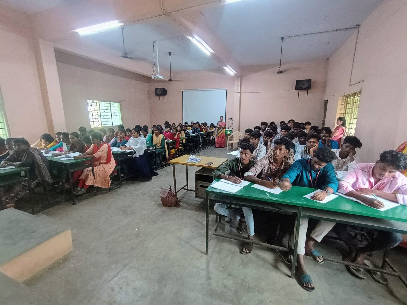 Rows of college students attending a lecture in a classroom