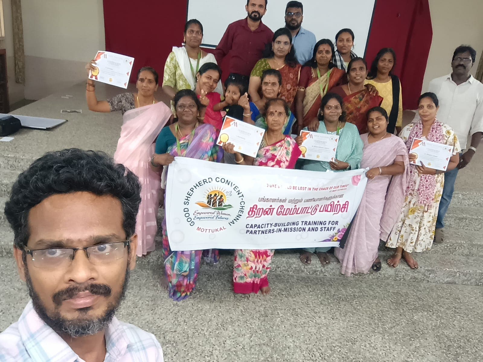 Group photo with certificates at a community capacity-building training event