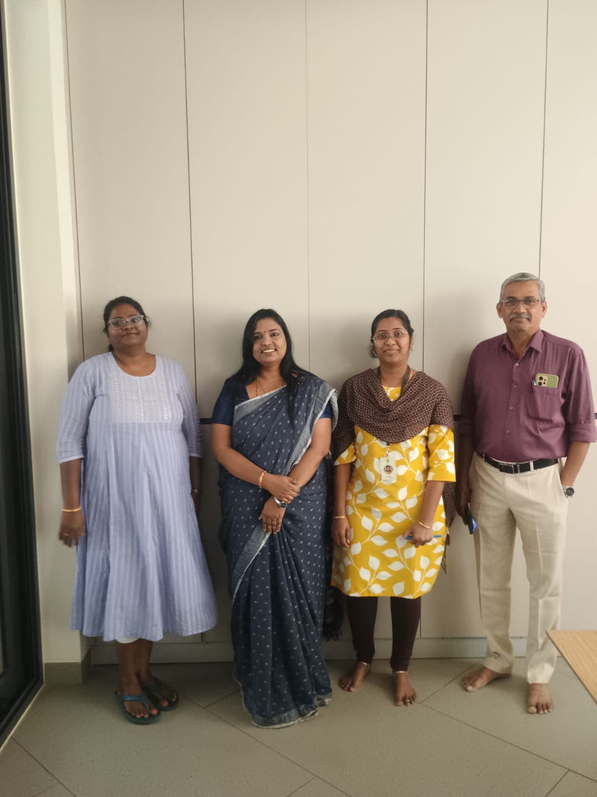 Group photo of colleagues in a corporate office